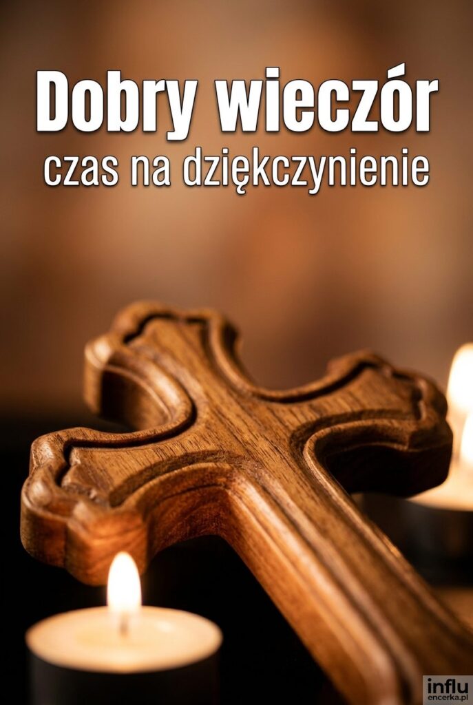 Detal drewnianego krzyża na ciepłym rozmytym tle i powitanie „Dobry wieczór”.